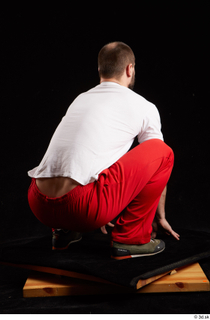 Orest  1 dressed grey shoes jogging suit kneeling red…